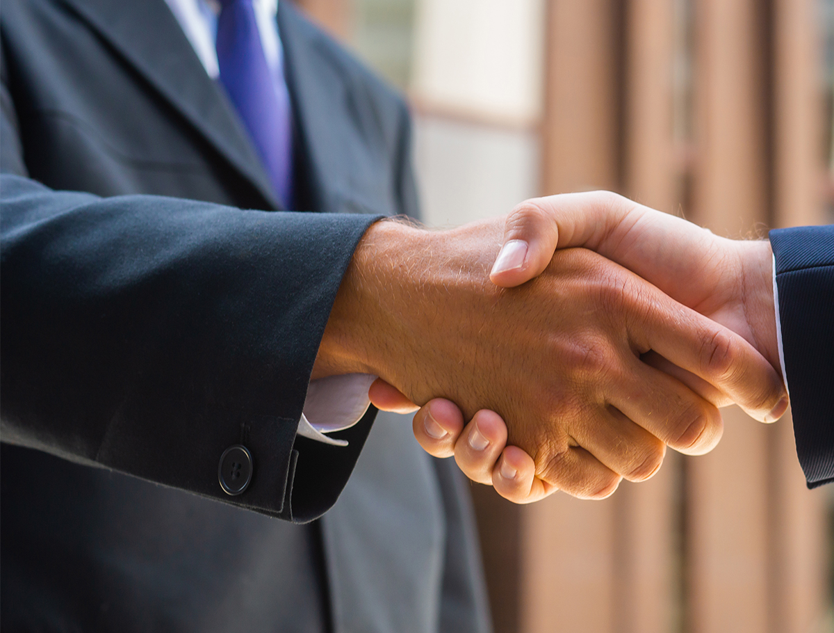 Close up of two business people hands shaking
